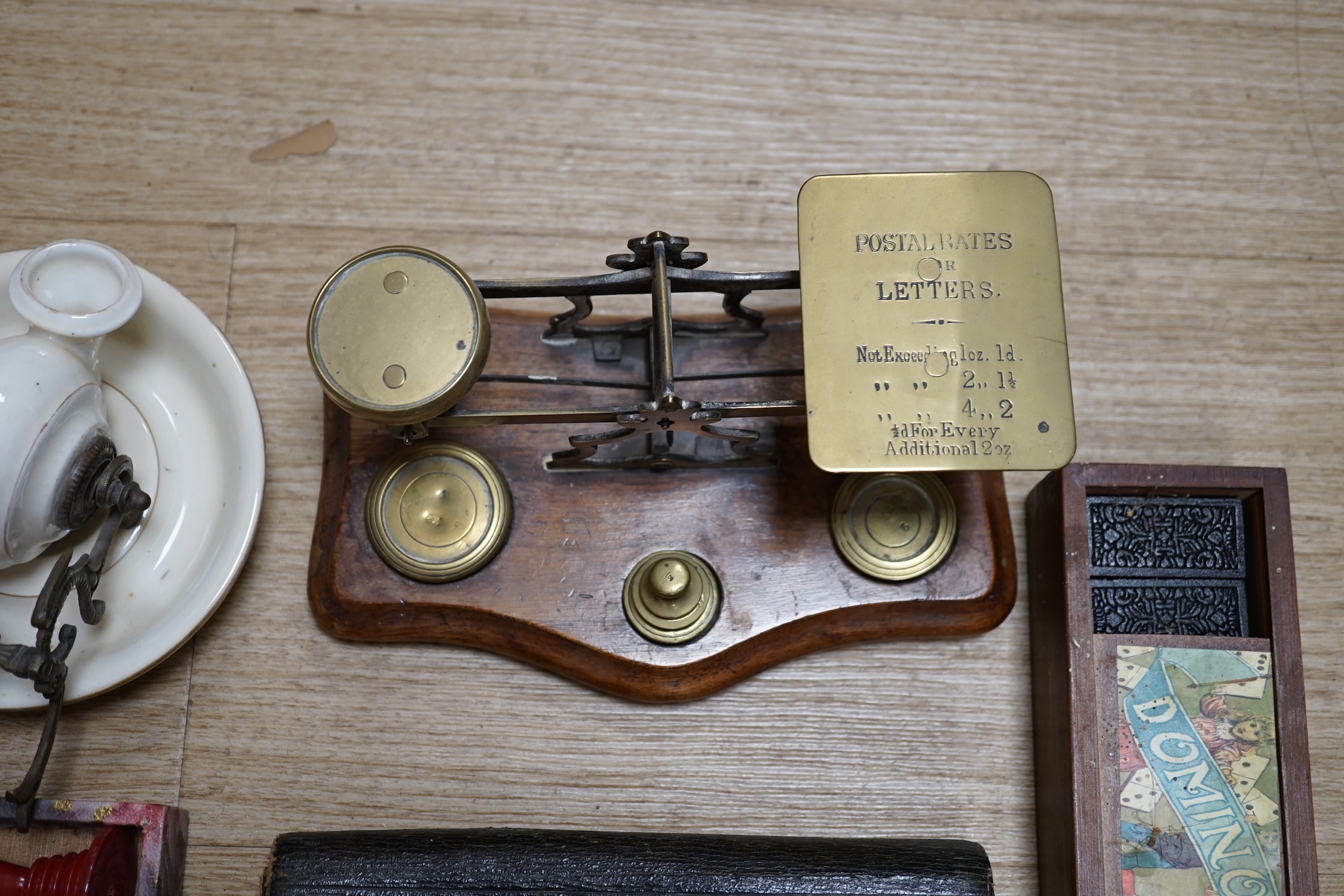 A pair of brass letter scales, a novelty ink pot, a Gladstone bag, a maple framed sketch, a googlie eyed doll’s head, a tin plate Jumbo toy, Dominoes, boxed seal kit and a leather travelling stationary case etc., scales